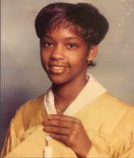 April in gold graduation regalia